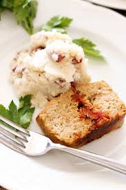 white plate conning feta and sun dried tomato meatloaf with mashed potatoes
