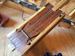 guitar is made from a century old cigar box