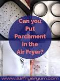 Where do you put the parchment paper in an air fryer?