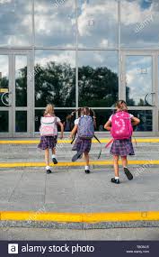 Group Of Elementary School Girls Running At School Back