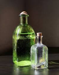 coloured glass bottles on a rustic