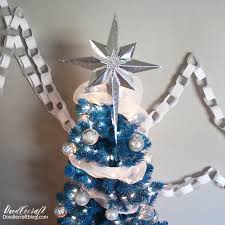 silver star tree topper on blue