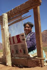 navajo woman weaving carpet monument