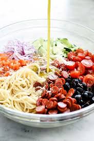 Add the cooled pasta to a large mixing bowl. Easy Italian Spaghetti Pasta Salad Foodiecrush Com Pasta Salad Ingredients Cold Spaghetti Salad Spaghetti Salad