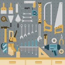 Set Of Tools Hanging On Peg Board Wall