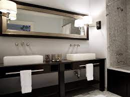 It's a dark wood vanity with a white counter, twin sinks, and elaborate lampshades. Double Vanities For Bathrooms Hgtv