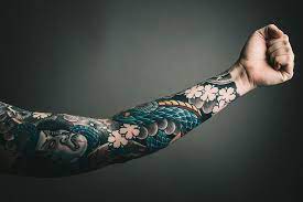 left arm with tattoo art colors