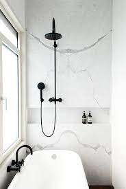 Black fixtures in marble bathrooms. Marble Trends Matte Black Fixtures White Marble The Davani Group