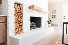 white brick fireplace with firewood