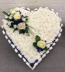 This style of funeral flower comes in the shape of an attractive arrangement and one that is suited both to the service and the home. Blue And White Base Funeral Heart Funeral Heart Flower Wreath Tribute