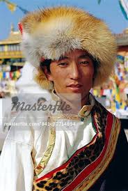 Young Tibetan man wearing typical hat and dress during Losar (Tibetan New  Year) at Bodhnath, Katmandu, Nepal - Stock Photo - Masterfile -  Rights-Managed, Artist: robertharding, Code: 841-02714894