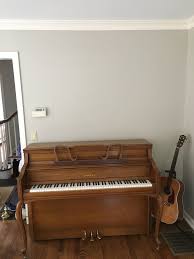 how to decorate wall above upright piano