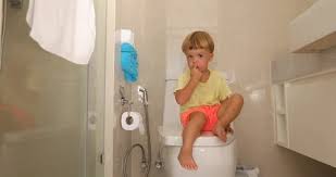Pensive Child Sitting On The Toilet