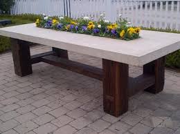 Natural stone tables will compliment and enhance both timber and paved outdoor dining areas. Barn Timber Stone Top Dining Table Mecox Gardens