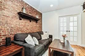 Brick columns with the wrought iron fencing make a beautiful design. Brick Wall Design For Small Living Room