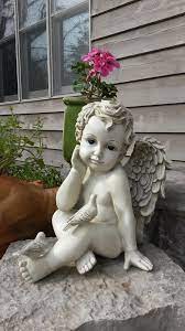 cherub garden statue with doves on