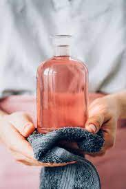Straining and using rose water for skin. How To Make A Rosewater Facial Toner Hello Glow