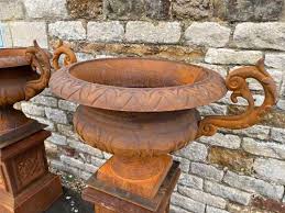 Pair Of Cast Iron Urns And Plinths