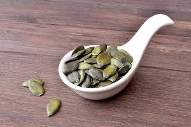 pumpkin seeds calories in 100g or ounce