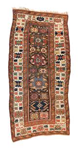 an antique kazak rug in size 7 x 4