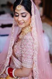 photo of bride wearing pink lehenga