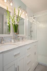 Small Bathroom With White Cabinets Under Two White Sinks White Wooden Framed Mirrors White Ceramic Bathrooms Remodel Trendy Bathroom Bathroom Light Fixtures