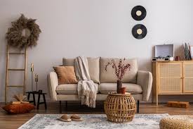 beige sofa with carpet pillow plaid