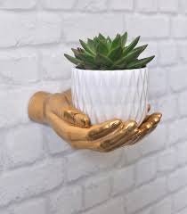 upcycled gold wall mounted hands plant