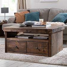 This coffee table is crafted of premium wood products and veneers with a sable finish. Derwent Rustic Solid Wood Coffee Table With Drawers
