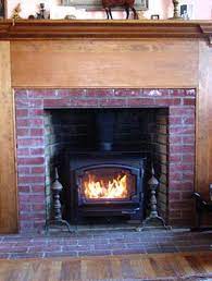 free standing wood stove in fireplace