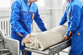 men workers cleaning get carpet from an