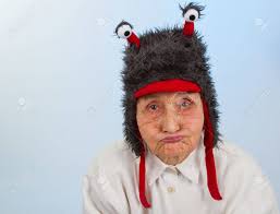 Very Old Lady In Funny Fur Hat With Two Tentacles With A Bored, Sulky  Expression Stock Photo, Picture And Royalty Free Image. Image 32431557.