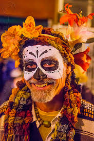 man with skull makeup and flower headdress