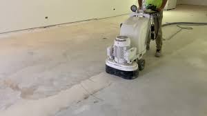 removing adhesive from concrete slabs