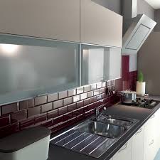 Impressive kitchen with burgundy backsplash, brick wall, wood storage combination. Burgundy Metro Tiles From Crown Tiles