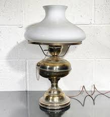 An Antique Brass Hurricane Lamp With