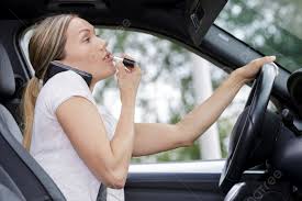 applying makeup while driving her car