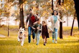 Happy Family With Two Children Running After A Dog Together Stock Photo  gambar png