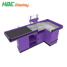 Young female cashier operating at the cash desk in cafe. China Supermarket Design Retail Cash Register Table Checkout Counter Cashier Desk With Conveyor Belt For Sale China Cash Table Cash Counter