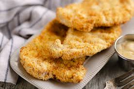 These air fryer pork chops are soaked in a brine to tenderize, then rubbed with a spice mix and air fried for 12 minutes until juicy! Crispy Air Fryer Breaded Pork Chops