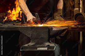 powerful hands of male blacksmith forge