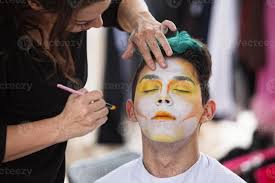 sylist putting makeup on clown 1358744