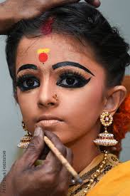 women or kid doing makeup wearing sari