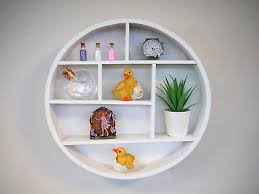 white wooden round wall shelf display