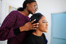 african american woman applying makeup