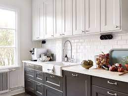 Another popular use of this idea is selecting different top and bottom cabinet finishes. Black And White Kitchen With White Top Cabinets And Black Bottom Cabinets Paired With White Countertops And Trendy Kitchen Tile Kitchen Cabinets Home Kitchens