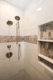 Are you after bathroom tile ideas? Marble Tiled Shower Walls With Brown Tiled Accent Bathroom Shower Walls Shower Tile Bathroom Wall Tile