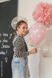 little girl decorate room with balloons