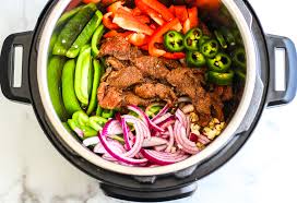 Smoky, flavorful flank steak and perfectly al dente peppers and onions all get cooked up in one pot! Instant Pot Steak Fajita Bowls Whole 30