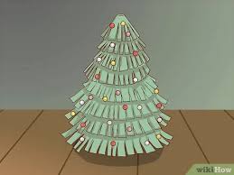 Pohon natal yang terbuat dari lembaran musik yang dipotong dan disatukan ini memberikan tekstur yang unik pada bentuk pohon. 5 Cara Untuk Membuat Pohon Kertas Untuk Anak Anak Wikihow